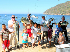 family with children showing off the large fish they caught