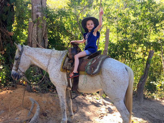 little girl horseback riding in mexico